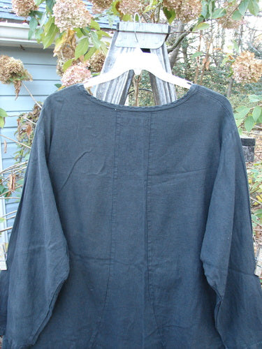 Barclay Woven Summercloth Figure 8 Pocket Tunic Dress Unpainted Forest Size 2 displayed on an outdoor swinger, showcasing its heavy weight long sleeves and unique pocket design.