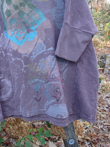 Barclay Hemp Cotton Banded Sleeve Dolman Top in Butterfly Maroon, featuring a floral pattern, exemplifies Bluefishfinder.com's vintage style. The purple jacket showcases creative, expressive fashion with distinctive, artistic flair.