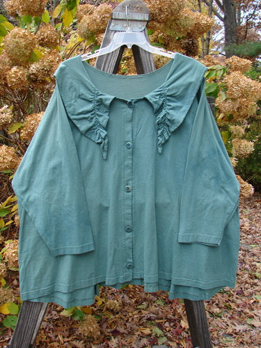 1994 Fallen Leaves Jacket on a swinger, made of Mid Weight Cotton, with a Uniquely Stitched and Gathered Pointed Collar, Blue Fish Buttons, and a Lovely Earthen Shade of Green.