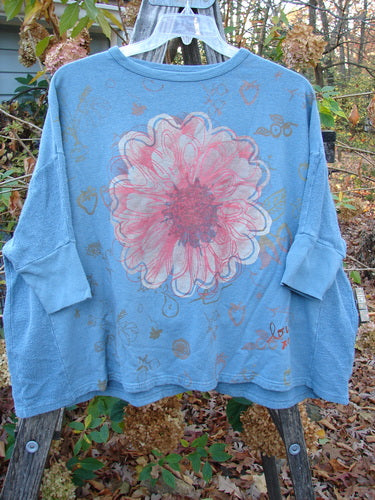 Barclay Hemp Cotton Banded Sleeve Dolman Top Mum Blue Dusk OSFA features a floral print on a blue shirt, highlighting its unique flower pattern, embodying Bluefishfinder.com's vintage-inspired, creative fashion ethos.