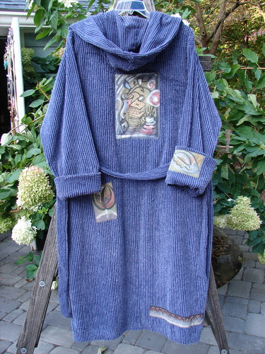 1995 Patched Hooded Chenille Spa Robe Study Mediterranean Size 3 displayed on a wooden stand, showcasing its double-layered hood, cuffed sleeves, oversized pockets, and signature painted patches.