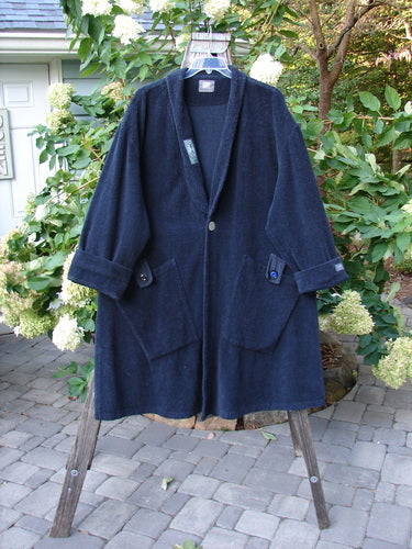 1999 Patched Chenille Angle Pocket Jacket Holiday Time Black Size 1 displayed on a hanger, showcasing oversized vintage button closure, floppy diagonal pockets, drop shoulders, and a detailed patched collar.