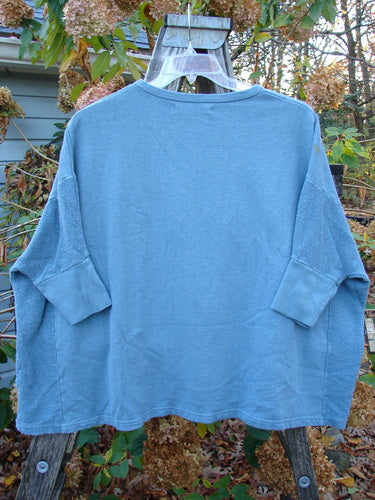 Barclay Hemp Cotton Banded Sleeve Dolman Top Mum Blue Dusk OSFA displayed on a hanger, highlighting its heavy-weight fabric and unique banded sleeves, embodying the vintage and creative spirit of Blue Fish Clothing.