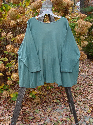 1994 Fallen Leaves Jacket in Nori Green, Size 2. Unpainted grey-green cotton jacket with unique stitched collar, A-line shape, and Blue Fish buttons.