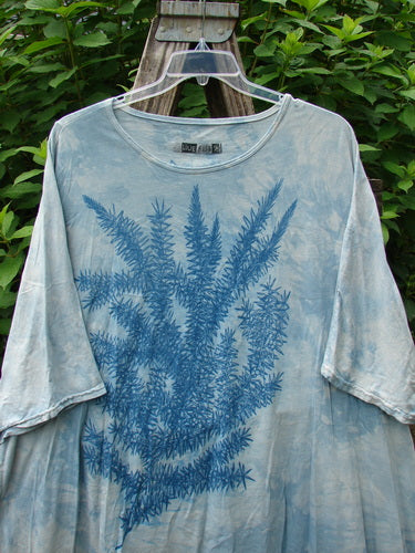 Barclay Art Tee Rosemary Sprig Mottled Day Sky OSFA features a blue leaf design on a white tunic with drop shoulders, three-quarter sleeves, and a unique hem, reflecting BlueFishFinder's vintage, expressive style.