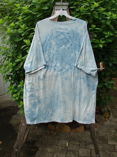 Barclay Art Tee Rosemary Sprig Mottled Day Sky OSFA features a longer tunic length, loose three-quarter sleeves, and a rounded neckline with a unique rosemary sprig design on the front.