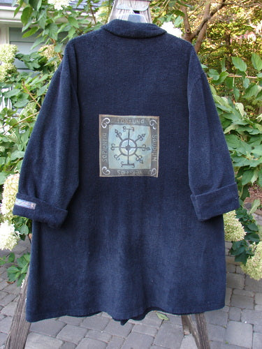 1999 Patched Chenille Angle Pocket Jacket Holiday Time Black Size 1 displayed on a hanger, featuring oversized button closure, folded and patched collar, drop shoulders, and two diagonal front pockets with vintage buttons.