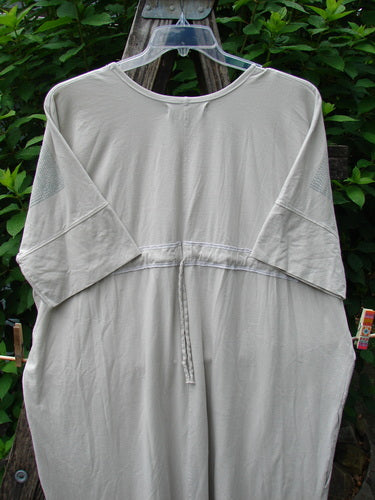 Barclay Long Tee Tie Back Dress Botanical Garden Rain Cream OSFA on a hanger, showcasing its seamless bodice, rounded neckline, dual pockets, and drawcord back, epitomizing BlueFishFinder's vintage style.