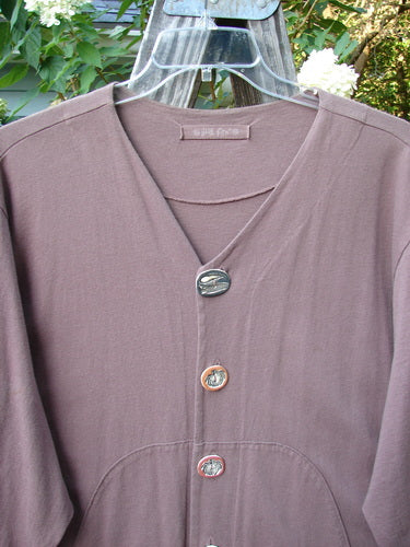 Close-up of the 1998 Harvest Jacket Veggie Garden Eggplant Size 2, showcasing its organic cotton fabric, oversized front pockets with veggie vine paint, and artisan porcelain buttons.