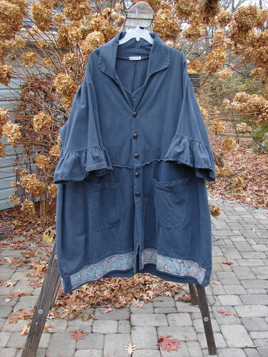 A Barclay Decora Brushed Twill Flutter Coat in Navy, size 2, featuring a larger fold-up neckline, dark matching buttons, a wrap-around rear with an upward-pointed waistline, flutter ruffle sleeves, giant drop pockets, and a swingy hemline. Made from a rich weighted super soft fabric with a tiny garden theme. Bust 60, waist 60, hips 62, sweep 75, lower bell 80, length 46 inches.
