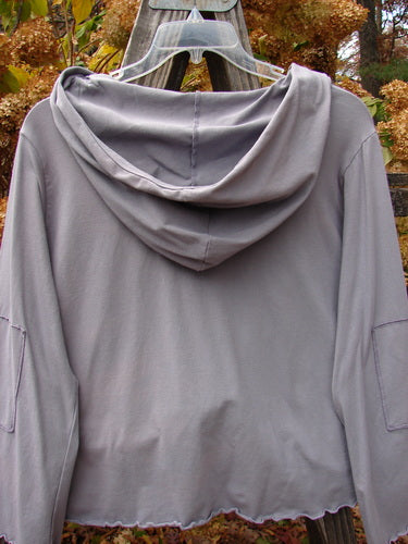 Barclay Patched Cotton Lycra Hooded Shrug Jacket on clothes rack.