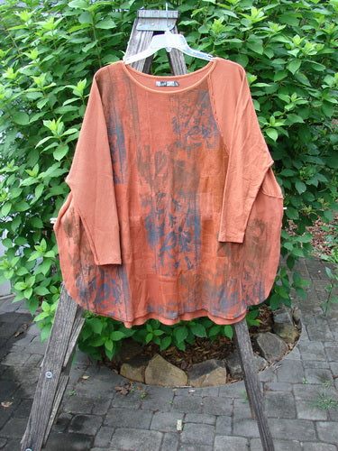 Barclay Thermal Monte Verde Vented Tunic Harvest Autumn OSFA displayed on a hanger, showcasing its rounded neckline, side vents, and exterior stitchery detailing against a botanical theme on organic cotton fabric.