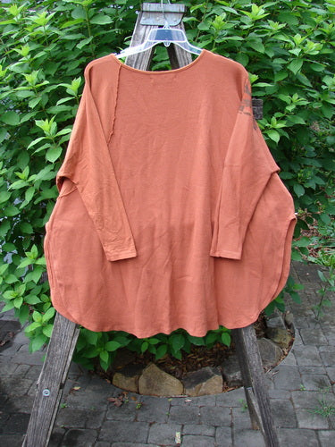 Barclay Thermal Monte Verde Vented Tunic Harvest Autumn OSFA displayed on a wooden rack, showcasing its rounded neckline, side vents, and botanical harvest theme paint with exterior stitchery contrast.