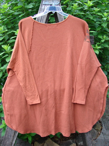 Barclay Thermal Monte Verde Vented Tunic Harvest Autumn OSFA displayed on a clothes rack, showcasing its rounded neckline, widening lower shape, side vents, slim sleeves, and contrasting stitchery on thermal and cotton fabric.