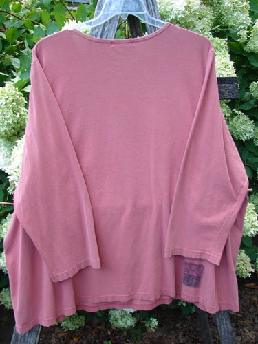 Barclay Long Sleeved Tee Studio Tee Triple Modernist in apricot, Size 3, a loose long-sleeved shirt with a wide crew neckline and soft, faded cotton texture. The back view shows a draped silhouette, uneven hem, and a small printed label near the lower right hem.
