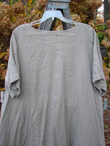 Barclay Linen Figure 8 Drop Pocket Tunic Dress on a wooden swinger, outdoor setting.