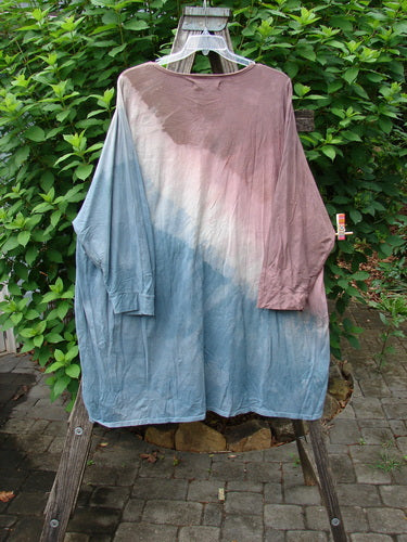 Barclay Art Tee Da Vinci Moon Mottled River OSFA displayed on a clothes rack, showcasing its tunic length, drop shoulders, loose three-quarter sleeves, rounded neckline, and unique hemline.