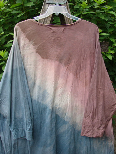 Barclay Art Tee Da Vinci Moon Mottled River OSFA displayed on a plastic hanger, showcasing its tunic length, rounded neckline, and three-quarter sleeves with unique artistic design elements.