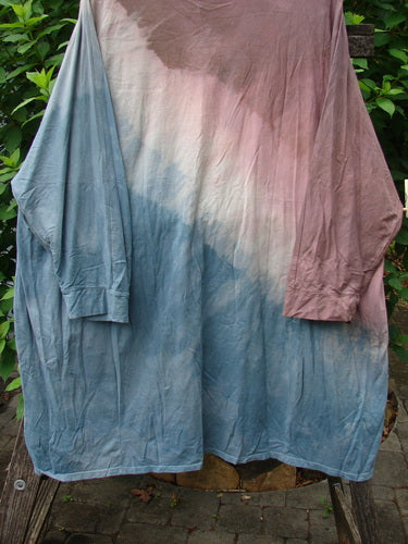 Barclay Art Tee Da Vinci Moon Mottled River OSFA, featuring a close-up of its medium-weight organic cotton fabric, shown draped over a tree stump, highlighting its tunic length and unique hemline design.