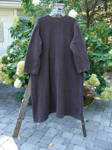 2000 Celtic Moss Hobo Coat Unpainted Brum Size 2 displayed on a wooden rack, showcasing its long, plush, and dense texture with metal buttons, belled sleeves, and signature patch.