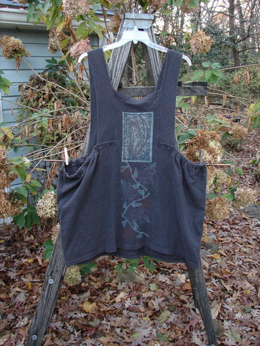 1995 Reprocessed Cottage Jumper Floral Vine Granite Size 3 displayed on a wooden rack, featuring a densely knit textured fabric with floral vine patterns, thick shoulder straps, and two large front pockets.