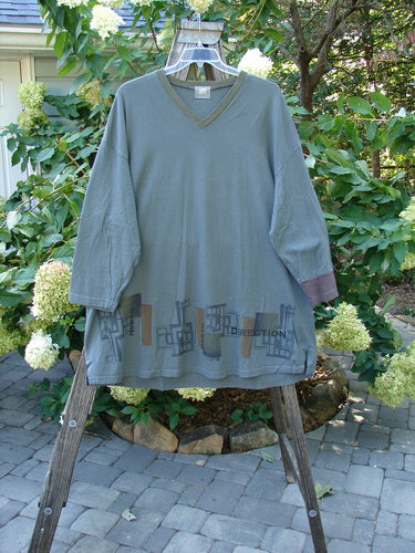 2000 V Neck Grid Top Directional Iron Size 2 on a rack, showcasing its unique painted design, single cuff, V neckline, and slightly rounded bottom sweep.