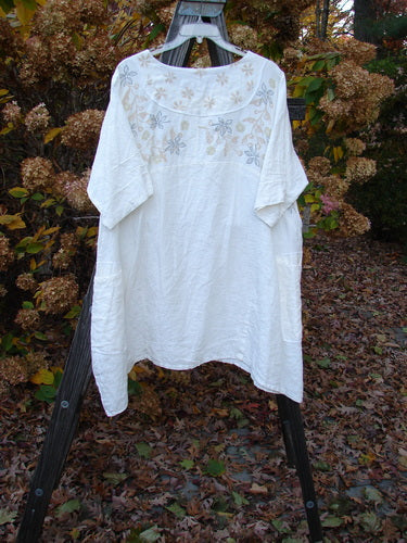 Barclay Linen Cross Over Dress with floral design on a swinger.