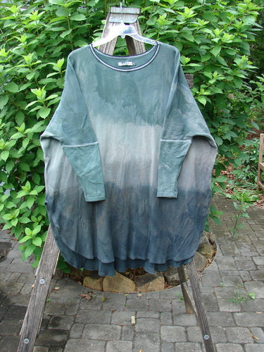 Barclay Thermal Contrast Revival Top in Mottled Sage, displayed on a clothes rack, highlighting its ribbed neckline and sleeves with an A-line shape and side vents, from Bluefishfinder.com.