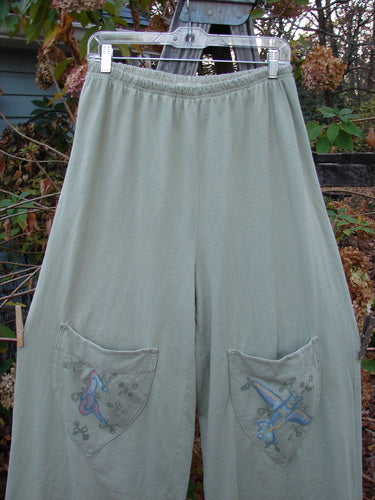 2001 Wishpocket Pant Airplane Kelp Size 1 features wide, cropped legs with two painted knee pockets, showcasing an airplane theme. The pants include a full elastic waistline, embodying Bluefishfinder.com's vintage style.