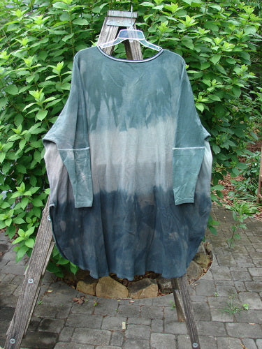 Barclay Thermal Contrast Revival Top Unpainted Mottled Sage Shade OSFA displayed on a clothes rack, showcasing ribbed sleeves, neckline, and a unique A-line shape with easy side vents.