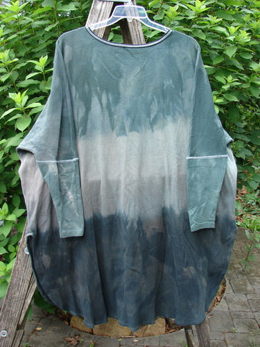 Barclay Thermal Contrast Revival Top in Mottled Sage features ribbed sleeves and neckline, displayed on a clothes rack, showcasing its unique A-line shape and easy side vents.