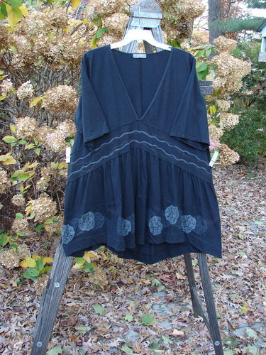 Barclay Deep V Banded Waist Tunic Dress on a swinger with leaves on the ground.