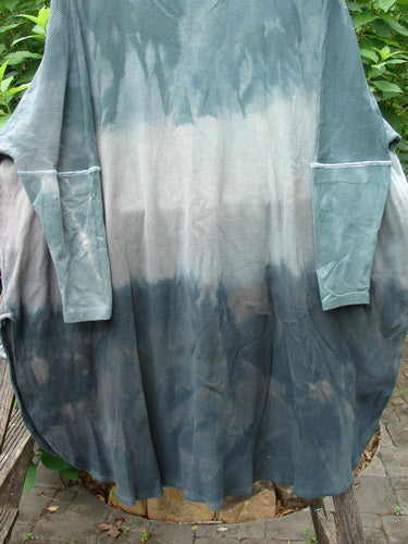 Barclay Thermal Contrast Revival Top in Mottled Sage Shade, displayed on a rope, showcasing ribbed sleeves and neckline, with a unique A-line shape and side vents, suitable for diverse body types.