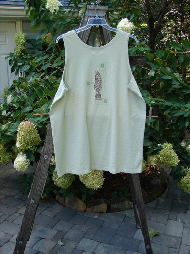 2000 Summer Tank Top Fish Dune Grass Size 2, mid-weight organic cotton, deeper arm openings, straighter longer shape, hand-painted fish design, displayed on a wooden rack.