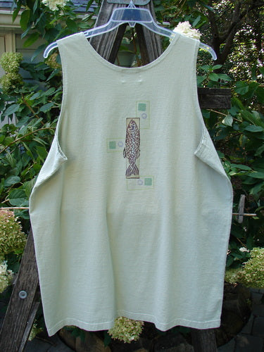 2000 Summer Tank Top Fish Dune Grass Size 2: A white tank top featuring a painted fish design, deeper arm openings, and a straighter, longer shape, made from mid-weight organic cotton.