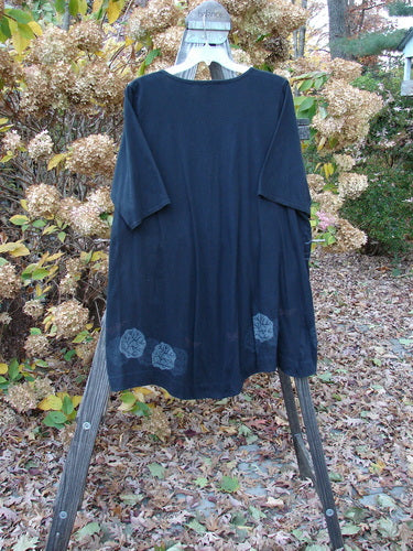 Barclay Deep V Banded Waist Tunic Dress on stand, clothing rack, and cloth.
