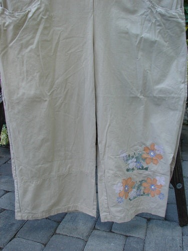 2000 Parachute Overall Pant Jumper Floral Dove Size 2, featuring hand-painted floral designs, oversized front bib pocket, deep side pockets, adjustable shoulder straps, and wide leg openings.