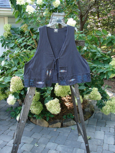 1999 Fishing Vest Fish School Orbit Size 2 displayed on a wooden stand, featuring fish embroidery, double-paneled front squared pockets, deeper arm openings, and a rear pocket, highlighting vintage Blue Fish Clothing style.