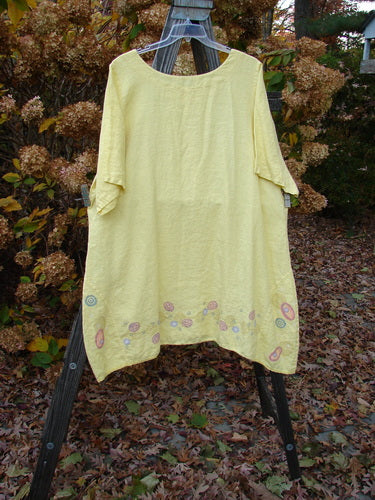 Barclay Linen Vertical Seam Lace Bottom Dress with Swirl Theme, Size 2, on clothes rack.