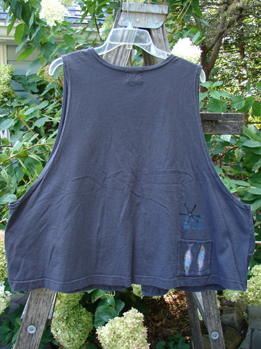 1999 Fishing Vest Fish School Orbit Size 2 displayed on a mannequin, featuring tie front, double paneled pockets, deeper arm openings, and fish school pattern, highlighting its vintage charm and organic cotton material.