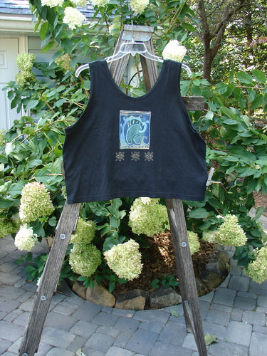 1997 Elements Crop Tank Wave Curl Ebony Size 2 displayed on a wooden ladder, showcasing its scooped neckline, deeper arm openings, and unique wave curl theme paint with a contrasting fish patch.