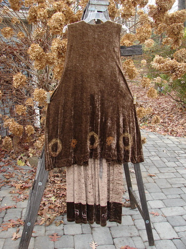 1997 Velvet Sanskrit Cosmos Duo Mandorla OSFA Size 2: A brown dress on a wooden stand with a brown velvet vest featuring a design.