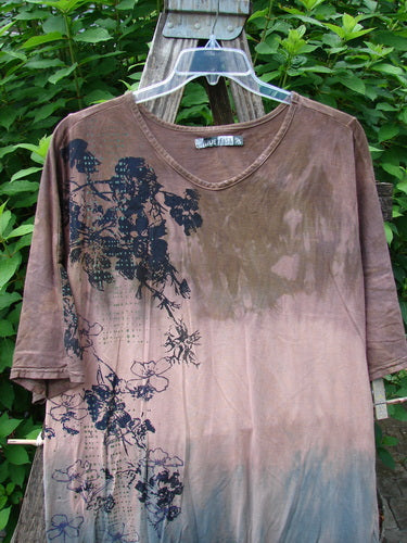 Barclay Tournesol Slim Tunic Dogwood Mottled Dusk OSFA featuring black floral patterns, a longer tunic length, drop shoulders, and loose three-quarter sleeves with a rounded neckline and varying hemline.