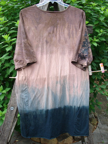 Barclay Tournesol Slim Tunic Dogwood Mottled Dusk OSFA hanging on a clothes rack, showcasing its longer tunic length, rounded neckline, drop shoulders, and three-quarter sleeves, embodying Bluefishfinder.com's vintage, creative style.