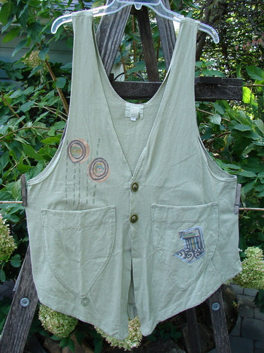 2001 Katy Vest Circle Rain Kelp Size 1 features a unique A-line shape, thin shoulder straps, two front triangular pockets, Blue Fish button closures, and a varying hemline with a painted circle rain design.