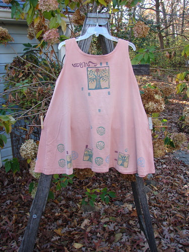 The 1991 Tab Dress Heart Tree Salmon Altered OSFA features a distinctive tree design, highlighting its unique vintage appeal, hanging gracefully on a swing, embodying BlueFishFinder's creative, expressive style.