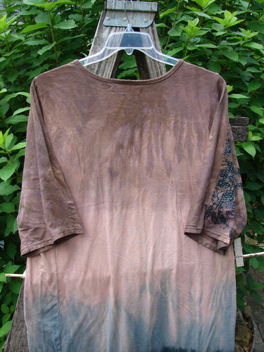 Barclay Tournesol Slim Tunic Dogwood Mottled Dusk OSFA hangs on a clothesline, showcasing its mid-length, loose three-quarter sleeves, and rounded neckline, embodying BlueFishFinder's unique vintage style.