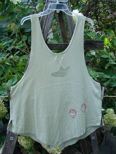 2001 Katy Vest Circle Rain Kelp Size 1 displayed on a hanger, showcasing its unique A-line shape, textured Blue Fish button closures, triangular pockets, and varying hemline.