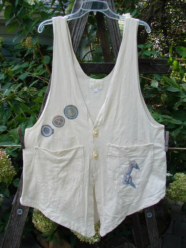 2001 Katy Vest Chain Rain Natural Size 1 - A white vest featuring two blue fish buttons, lengthy thinner shoulder straps, a wider rounded A-line shape, triangular pockets, and a unique varying hemline.