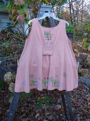 1991 Tab Dress Heart Tree Salmon Altered OSFA: Pink dress featuring a unique heart and tree design, displayed outdoors on a swing, aligning with Bluefishfinder.com's vintage aesthetic.